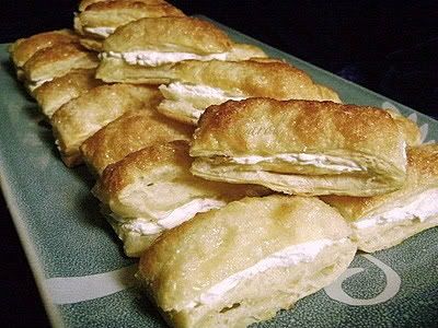 /><br/> <br/> Are you looking for a quick and easy dessert that will make ONE BIG SPLASH when served? This is the one for you!<br/> <br/> The filling can be made ahead and refrigerated AND you can change the flavor by using your favorite extract....it's one VERY versatile recipe.<br/> <br/> They're also good with chocolate glaze drizzled over the top. MMMMM!!!!<br/> <br/> Carol<br/> <br/> <br/> CREAM FILLED PUFF PASTRY<br/> <br/> PASTRY:<br/> 1 (17.3 oz.) pkg. frozen puff pastry sheets, thawed per package directions<br/> 1 egg<br/> 1/4 c. milk<br/> 1-2 Tbsp. coarse sugar (granulated sugar works just fine too-the coarse sugar gives a nice crunch to the top of the puff pastry)<br/> <br/> Remove pastry from box. Unwrap and allow it to sit on the counter @ room temperature for 10-20 minutes-just long enough to be able to unfold the pastry without it breaking.<br/> <br/> Carefully open one pastry sheet along the creases; place remaining sheet in the refrigerator to keep it cold. Using a long, sharp knife, cut each strip of pastry at creases, forming 3 strips. Cut each strip widthwise into 7 pieces, slicing straight down-don't drag the knife across the pastry. (I cut the pastry when it's partially frozen-as long as I can get the thing unfolded and it doesn't tear, I proceed...the pastry seems to puff higher if it's not thawed all the way through.) Flip each cut piece over to place the side you cut on down onto the sheet.<br/> <br/> Combine egg and milk; lightly brush over pastry. Sprinkle with sugar. Place pastry on lightly greased baking sheets, leaving room between each piece (I usually use 3 baking sheets).*<br/> <br/> *I find it a little easier to put the cut pastry on the sheets, THEN brush with the egg and sprinkle the sugar.<br/> <br/> Bake @ 400 degrees for 10-12 minutes or until golden brown. Remove to a wire rack and cool completely. Using a serrated knife, slice through the center to make top and bottom halves.<br/> <br/> <br/> CREAM FILLING:<br/> 1 c. whole milk<br/> 5 Tbsp. all-purpose flour<br/> 1 c. granulated sugar<br/> 1/2 tsp. salt<br/> 1/2 c. shortening<br/> 1/2 c. butter or margarine, at room temperature<br/> 1 tsp. vanilla extract<br/> <br/> Place flour in a small saucepan; slowly whisk in milk until mixture is smooth. Cook, whisking constantly, over low heat until mixture thickens and comes to a boil. Remove from heat; place mixture into a small bowl. Cover bowl with a paper towel; cool to room temperature.<br/> <br/> Place cooled mixture in bowl of electric mixer; beat until fluffy. Add remaining ingredients, one at a time, and continue beating on medium-high speed for 5-10 minutes or until light and fluffy (I use my KitchenAid mixer-I start with the paddle, then when all the ingredients are very well mixed, I switch to the whisk attachment and let that do the rest of the work). The mixture should look like a whipped cream type frosting. I rub a little of it between my fingers to make sure the sugar has totally dissolved.<br/> <br/> Spread about 1 Tbsp. of filling on bottom half of each pastry (BE GENEROUS-you can always go back if you run out of filling towards the end and 